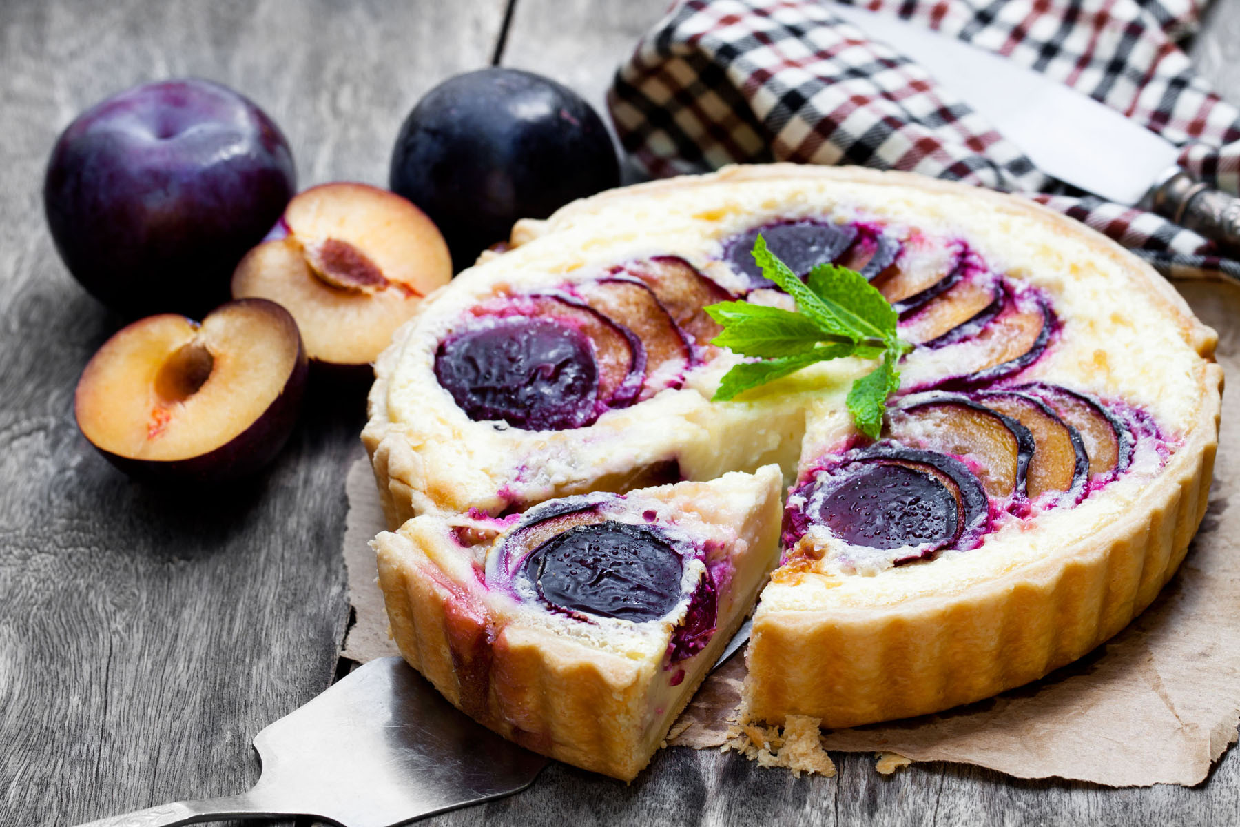 Homemade plum pie on wooden table
